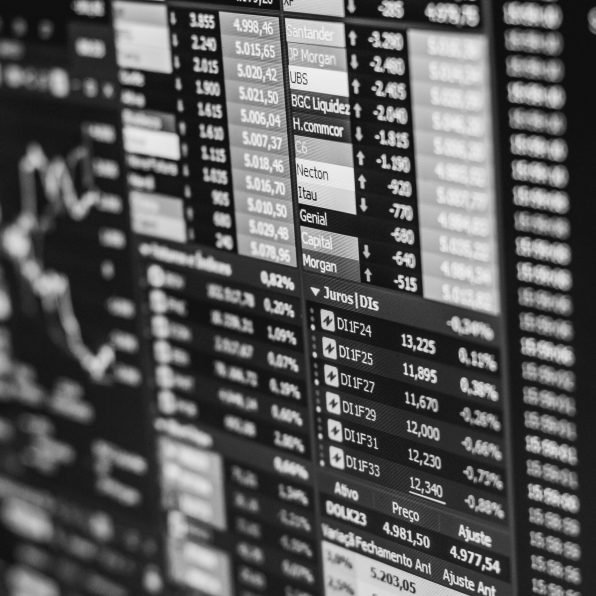 Monochrome image of stock market data on a screen, depicting financial information and trends.